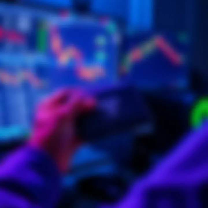 A person holding a Tangem cold wallet while looking at a computer screen showing cryptocurrency charts